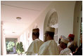 The Nigerian delegation stands along the colonnade as President George W. Bush talks with Nigerian President Olusegun Obasanjo May 11, 2001. President Bush thanked President Obasanjo for sending a message of tolerance and respect and assured him that the global war on terrorism is a fight against terror and evil and not against Muslims, whose Islamic faith teaches peace and respect for human life.