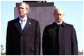 Presidents Bush and Putin participate in a wreath-laying ceremony at Piskarevskoye Cemetery in St. Petersburg , Russia, May 25.