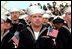 Sailors listen to President George W. Bush aboard the USS Enterprise in Norfolk, Va., on the 60th anniversary of the Pearl Harbor attack Dec. 7, 2001. "Today is an anniversary of a tragedy for the United States Navy," said the President. "Yet, out of that tragedy, America built the strongest Navy in the world. And there is no better symbol of that strength than the USS Enterprise."