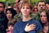 Family members of Air Force personnel place their hands over their hearts at Elmendorf Air Force Base in Anchorage, Alaska, Feb. 16, 2002. "I'm honored to be in a place where people understand the need for sacrifice and patriotism," said the President. "And I've come to Alaska to let you know that I'm proud of our United States military; that when I sent you into action, I knew you would not let this nation down."