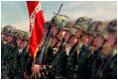 Welcoming President George W. Bush, marines carry the United States and Marine Corps flags at Camp Pendleton, Calif., May 29, 2001. "Camp Pendleton serves as the launching pad for what Marines do best.to deploy rapidly so you can be the first on the scene wherever freedom and America's interests are threatened," said the President. "Today, you carry forward this proud tradition, ready to answer when America calls."