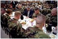 President George W. Bush prays with troops before sharing Thanksgiving dinner at Fort Campbell, Ky., Nov. 21, 2001. "This Thanksgiving, Americans are especially thankful for our freedom," said the President. And we are especially thankful to you, the people who keep us free."