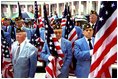 Members of the American Legion hold flags during a Veterans Day ceremony at Arlington National Cemetery in Arlington, Va., Nov. 11, 2002. "This is a place of national mourning and national memory," said the President. "We remember those who served America by fighting and dying on the field of battle. And we remember those veterans who lived on for many decades to serve America in many ways."