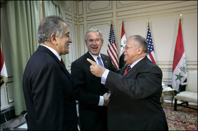 President George W. Bush shakes hands with Iraqi President Jalal Talabani, right, during his visit Tuesday, June 13, 2006, to the U.S. Embassy in Baghdad. With them is U.S. Ambassador to Iraq Zalmay Khalilzad. White House photo by Eric Draper 