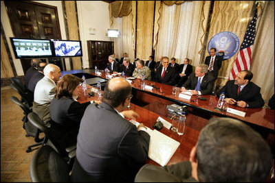 From Baghdad, President George W. Bush and Prime Minister Nouri al-Maliki of Iraq, hold a teleconference with Vice President Dick Cheney, Secretary of State Condoleezza Rice and Secretary of Defense Donald Rumsfeld in Camp David, Md., during a teleconference Tuesday, June 13, 2006. White House photo by Eric Draper 