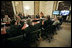 From Baghdad, President George W. Bush and Prime Minister Nouri al-Maliki of Iraq, wave to Vice President Dick Cheney, Secretary of State Condoleezza Rice and Secretary of Defense Donald Rumsfeld in Camp David, Md., during a teleconference Tuesday, June 13, 2006. White House photo by Eric Draper 