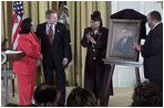 Proclaiming a holiday in honor of Martin Luther King, Jr., President George W. Bush receives a portrait of the civil rights leader from his wife and children in the East Room Jan. 21, 2002. Photographed from left to right are Coretta Scott King, the President, Rev. Bernice King and Martin Luther King III.