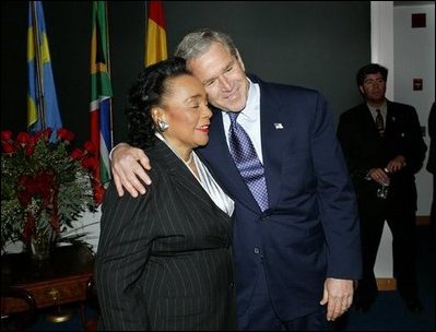 President George W. Bush hugs Coretta Scott King after laying a wreath laying at the grave of Dr. Martin Luther King, Jr. in Atlanta, Georgia, Thursday, Jan. 15, 2004.