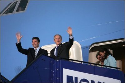 President George W. Bush and Prime Minister Anders Fogh Rasmussen wave from Air Force One upon the President's arrival to Kastrup, Denmark, Tuesday, July 5, 2005.