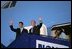 President George W. Bush and Prime Minister Anders Fogh Rasmussen wave from Air Force One upon the President's arrival to Kastrup, Denmark, Tuesday, July 5, 2005.