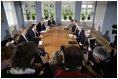 President George W. Bush meets with Danish Prime Minister Anders Fogh Rasmussen, center, left, at his summer residence in Marienborg in Kongens Lyngby, Denmark, Wednesday, July 6, 2005.  "We share the belief that freedom is universal, and we share the belief that in the struggle between democracy and dictatorship, you cannot stay neutral," said Prime Minister Rasmussen. "This is why Denmark contributes with more than 500 troops in Iraq; why we make an active contribution to the joint allied effort in Afghanistan; why we wish to promote democracy and reform in the Middle East; and why we urge all parties to find a peaceful solution to the Arab-Israeli conflict." 