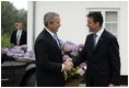 President George W. Bush is greeted by Danish Prime Minister Anders Fogh Rasmussen at his summer residence in Marienborg in Kongens Lyngby, Denmark, Wednesday, July 6, 2005.