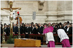 Archbishop Piero Marini, left, master of the liturgical ceremonies, bows to the casket of Pope John Paul II during the Pope's funeral Friday, April 8, 2005, in St. Peter's Square.