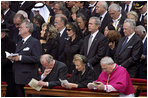 President George W. Bush and Laura Bush attend funeral services Friday, April 8, 2005, for the late Pope John Paul II in St. Peter's Square. The funeral is being called the largest of its kind in modern history.