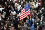 An American flag flies high among the throng of mourners inside St. Peter's square Friday, April 8, 2005, as thousands attend funeral mass for Pope John Paul II, who died April 2 at the age of 84.