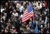 An American flag flies high among the throng of mourners inside St. Peter's square Friday, April 8, 2005, as thousands attend funeral mass for Pope John Paul II, who died April 2 at the age of 84.