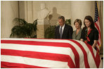 President George W. Bush and Laura Bush pay their respects to Chief Justice William Rehnquist as his body lies in repose in the Great Hall of the U.S. Supreme Court Tuesday, Sept. 6, 2005. Standing as honor guard for the Chief Justice is one of his former law clerks, Courtney Ellwood. White House photo by Eric Draper