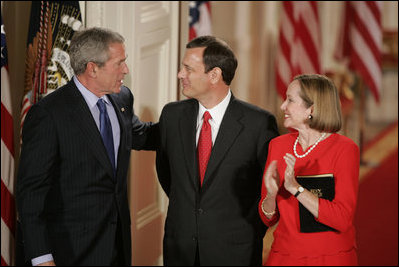 President George W. Bush, Thursday, Sept. 29, 2005 in the East Room of the White House in Washington, congratulates Chief Justice John G. Roberts and his wife Jane, after he is sworn-in as the 17th Chief Justice of the United States.