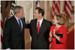 President George W. Bush, Thursday, Sept. 29, 2005 in the East Room of the White House in Washington, congratulates Chief Justice John G. Roberts and his wife Jane, after he is sworn-in as the 17th Chief Justice of the United States.