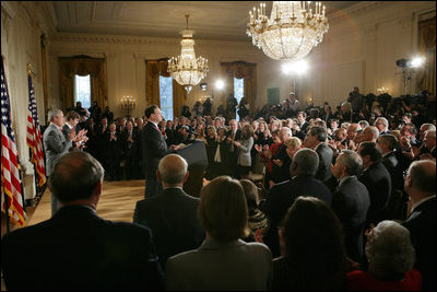 President George W. Bush, left, listens as newly confirmed U.S. Supreme Court Justice Samuel Alito addresses an audience, Tuesday, Feb. 1, 2006 in the East Room of the White House, prior to being sworn-in by U.S. Supreme Court Chief Justice John Roberts.