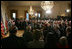 President George W. Bush, left, listens as newly confirmed U.S. Supreme Court Justice Samuel Alito addresses an audience, Tuesday, Feb. 1, 2006 in the East Room of the White House, prior to being sworn-in by U.S. Supreme Court Chief Justice John Roberts.