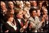 Standing at the far right, Haider Al-Jebori, President of the Steering Committee for Iraqi Home Culture, applauds for President George W. Bush at the Ford Community and Performing Arts Center in Dearborn, Mich., Monday, April 28, 2003. 