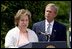 President George W. Bush listens to Betsy Rogers, 2003 National Teacher of the Year, in a ceremony in the East Garden Wednesday, April 30, 2003. Rogers is a 1st and 2nd grade teacher at Leeds Elementary School in Leeds, Ala.