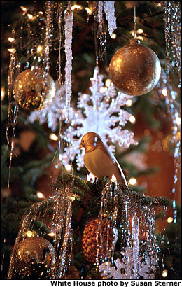 Clusters of snow covered and icicle-laden trees in the East Room accentuate the room’s grandeur. The pinecones and icicles are new ornaments this year. White House photo by Susan Sterner