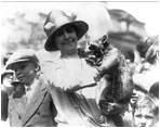 First Lady Grace Coolidge shows off her pet racoon, Rebecca, at the White House Easter Egg Roll April 18, 1927. The president built a little house for Rebecca. 