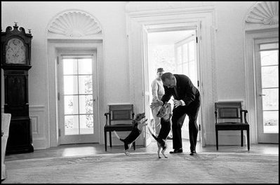 President Lyndon B. Johnson (1963-68) receives a greeting from his beagles, Him and Her. Johnson's beagles made the cover of Life magazine. 