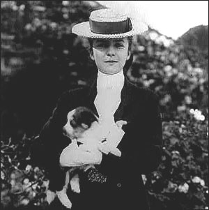 Theodore Roosevelt's oldest child, Alice, holds her dog on the White House lawn, June 17, 1902. Alice also owned a snake, which died a suspicious death at the hands of one of her siblings. 