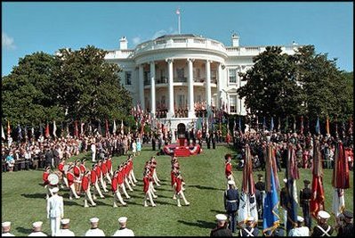 Playing for a large crowd of press and visitors, the U.S. Army Old Guard Fife and Drum Corps march across the South Lawn during the State Arrival Ceremony.