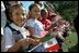 Waving little flags of our two neighboring nations, future VIP's watch the ceremonies.