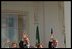 Waving from the White House balcony, President Bush welcomes Mexican President Vicente Fox during the President's First State Visit Sept. 6.