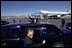 President George W. Bush waves to a crowd of people who came to see him off on his visit to Latin America at his departure from El Paso Thursday, March 21, 2002. White House photo by Eric Draper