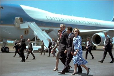 President George W. Bush and Mrs. Bush walk with President Francisco Flores and Mrs. Lourdes Rodriguez de Flores during the arrival ceremony welcoming President Bush to San Salvador in El Salvador, Sunday, March 24, 2002. White House photo by Tina Hager