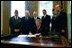 President George W. Bush signs H.R. 3365, The Military Family Tax Relief Act of 2003 in the Oval Office on Veterans Day, Nov. 11, 2003. The legislation provides tax-relief for military and Foreign Service personnel. Pictured with the President are, from left: John Brieden, American Legion National Commander; Congressman James McGovern, R-Mass.; Congressman Rick Renzi, R-Ariz.; Secretary of Veterans Affairs Anthony Principi; Jim Mueller, Veterans of Foreign Wars, Junior Vice Commander-in-Chief; and Admiral Norb Ryan, Military Officers Association of America.