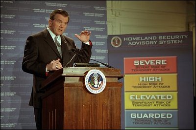 Governor Tom Ridge announces the Homeland Security Advisory System designed to measure and evaluate terrorist threats in Washington, D.C., March 12, 2002. It is based on threat conditions of five different alerts: low (green), guarded (blue), elevated (yellow), high (orange) and severe (red). 