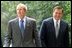 President Bush and Governor Ridge walk together on the South Lawn of the White House Sept. 19, 2002.