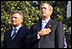 President George W. Bush and Laura Bush stand with Polish President Aleksander Kwasniewski and his wife Jolanta Kwasniewska for the playing of the national anthems for Poland and the United States during the State Arrival Ceremony on the South Lawn of the White House Wednesday, July 17, 2002. White House photo by Susan Sterner