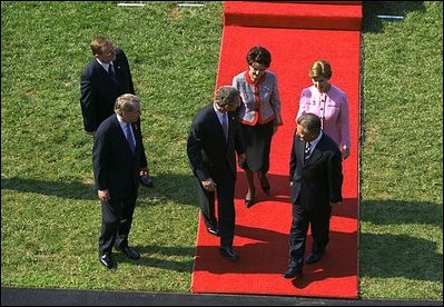 As they walk toward the White House after the ceremony, President Bush talks with his visitors. The tradition of greeting heads of state stretches back 128 years.