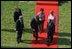 As they walk toward the White House after the ceremony, President Bush talks with his visitors. The tradition of greeting heads of state stretches back 128 years.