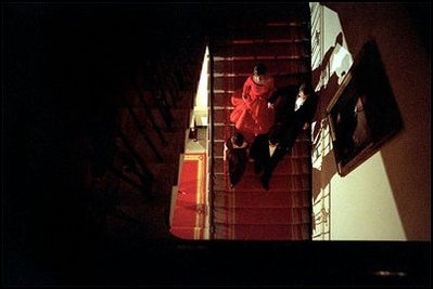 Walking hand in hand, President Bush, Mrs. Laura Bush and Mexican President Vicente Fox and Mrs. Fox descend the residential staircase to the state dinner held in President Fox's honor at the White House Wednesday evening. "A long border lies between us, but it does not divide us," said President Bush during his State Dinner remarks.