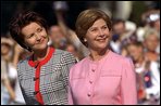 Mrs. Bush and Mrs. Kwasniewska stand together during the South Lawn ceremony at which the national anthems for both countries were performed and their husbands reviewed the troops. White House photo by Susan Sterner.