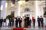 Flanked by some of America’s finest servicemen, President Bush and Mrs. Bush wave to photographers with President Kwasniewski and Mrs. Kwasniewska as they welcome Poland’s first couple to the State Dinner July 17. White House photo by Susan Sterner.