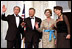 Flanked by some of America’s finest servicemen, President Bush and Mrs. Bush wave to photographers with President Kwasniewski and Mrs. Kwasniewska as they welcome Poland’s first couple to the State Dinner July 17. White House photo by Susan Sterner.