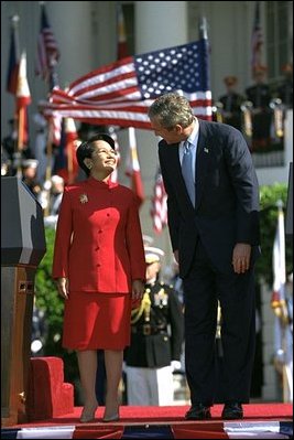 Sharing the stage with President Bush, Philippine President Arroyo is given a warm welcome by volleys of enthusiastic cheers during the South Lawn ceremony. 