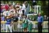 President Bush starts off the first game of the 2004 White House Tee Ball season with the pledge of allegiance June 13, 2004. Standing with the President are members of Girl Scout Troop 