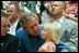 During the game, President Bush spends a few moments with a little league fan.