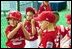 Suited up in red, the Cherry Point Marine Corps Air Station Devil Dogs prepare for their turn at bat during a game against the Bolling Air Force Base Little League Cardinals June 13, 2004. The Devil Dogs hail from Havelock, N.C., and the Cardinals are from Washington, D.C. 